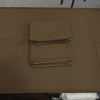 A stack of folded brown fabric, likely table linens or napkins, placed on top of a larger matching brown sheet or mat on a table.